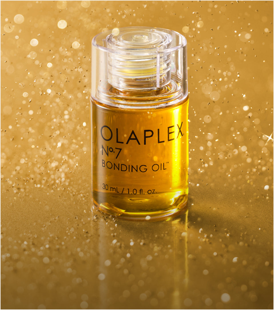 OLAPLEX No.7 Bonding Oil™ on a gold surface
