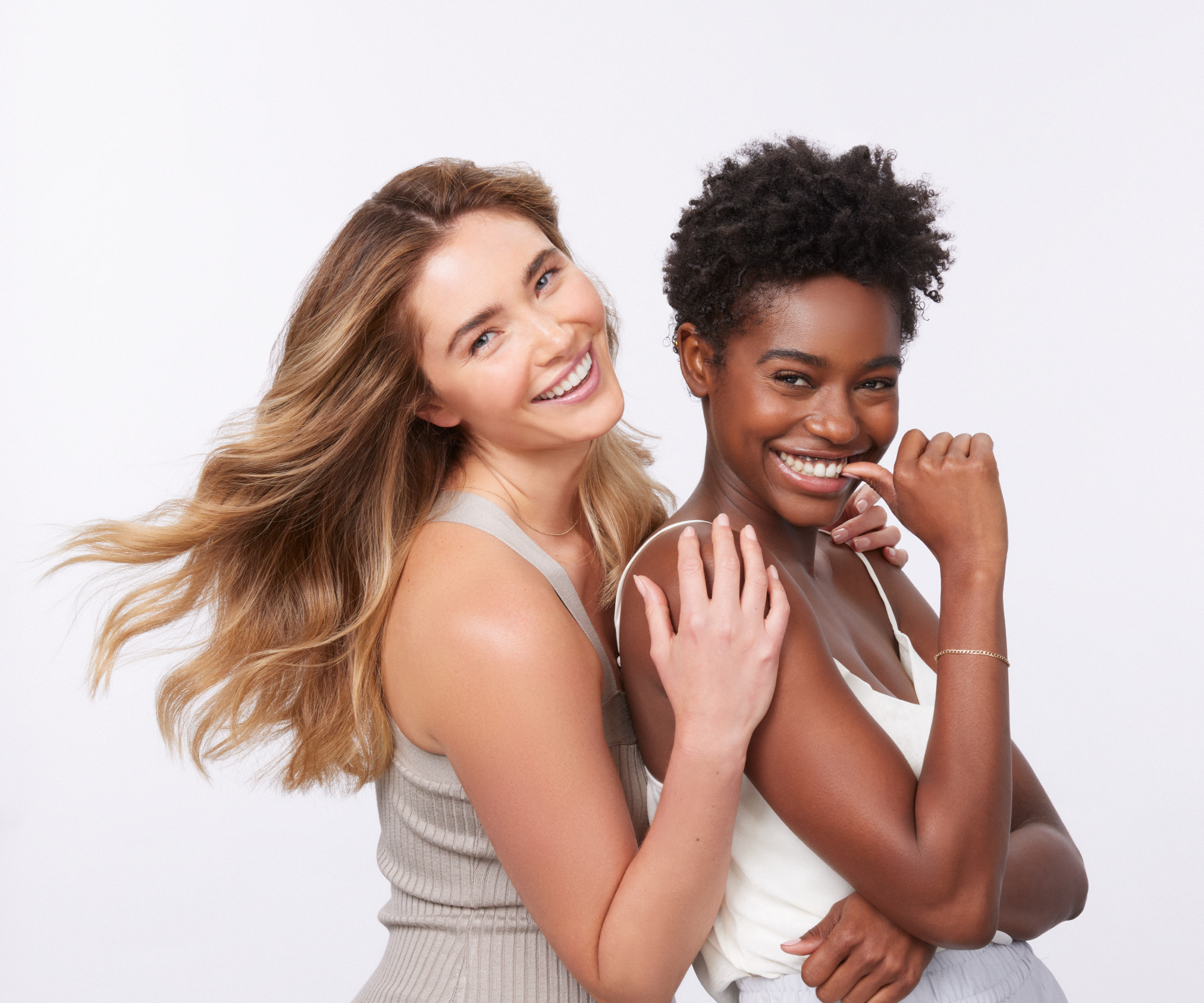 Two women posing and smiling together