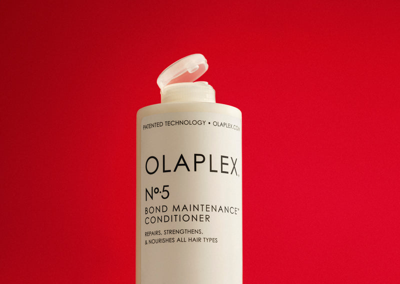 No.5 Bond Maintenance® Conditioner in front of a red background