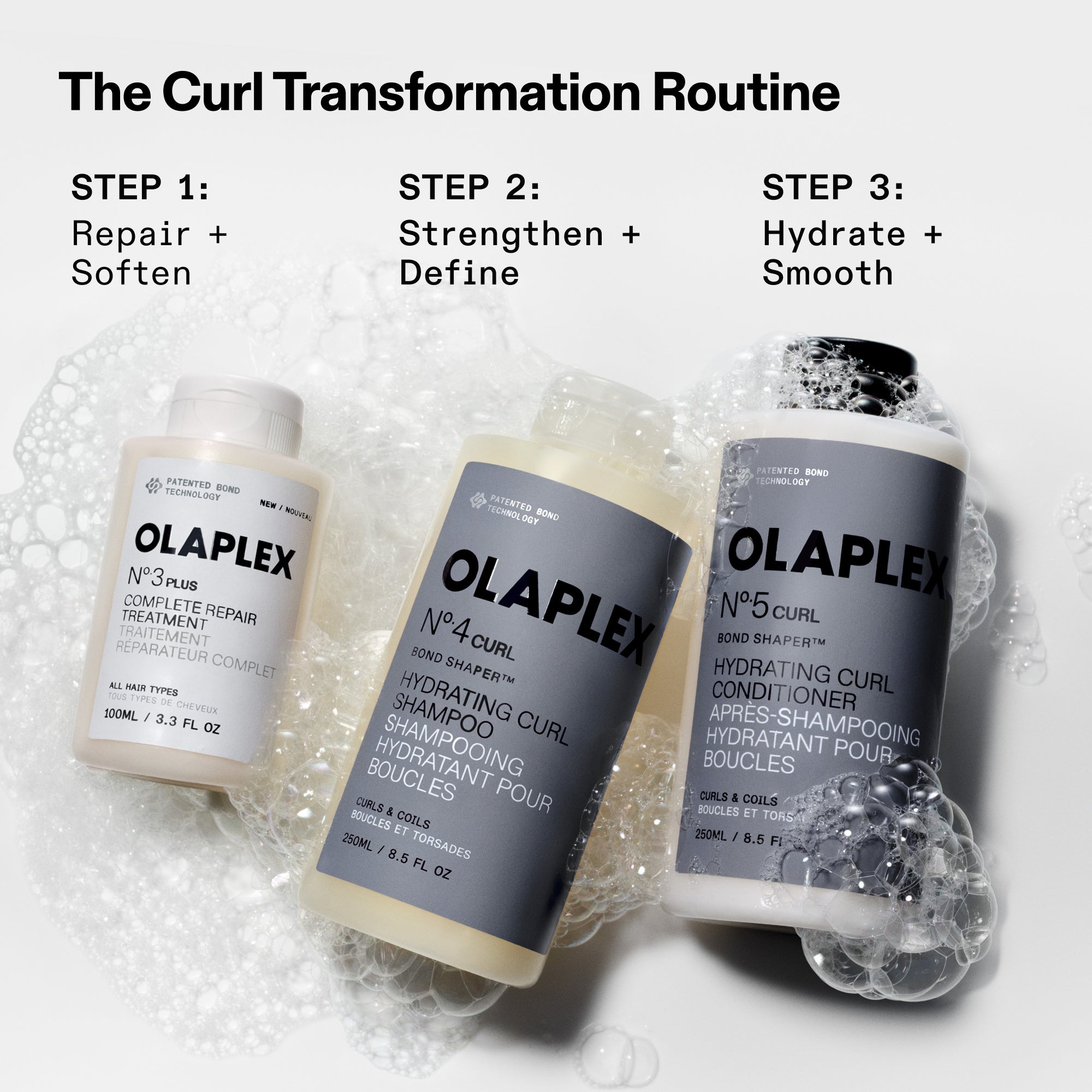 Infographie intitulée « La routine de transformation des boucles » présentant trois étapes avec des produits. Étape 1 : Réparez et adoucissez en utilisant le N°.3 Plus Complete Repair Treatment. Étape 2 : Renforcez et définissez vos boucles à l’aide du N°.4CURL Bond Shaper Hydrating Curl Shampoo.. Étape 3 : Hydratez et lissez vos boucles avec le N°.5CURL Bond Shaper Hydrating Curl Conditioner. Les bouteilles sont montrées reposant dans des bulles savonneuses.