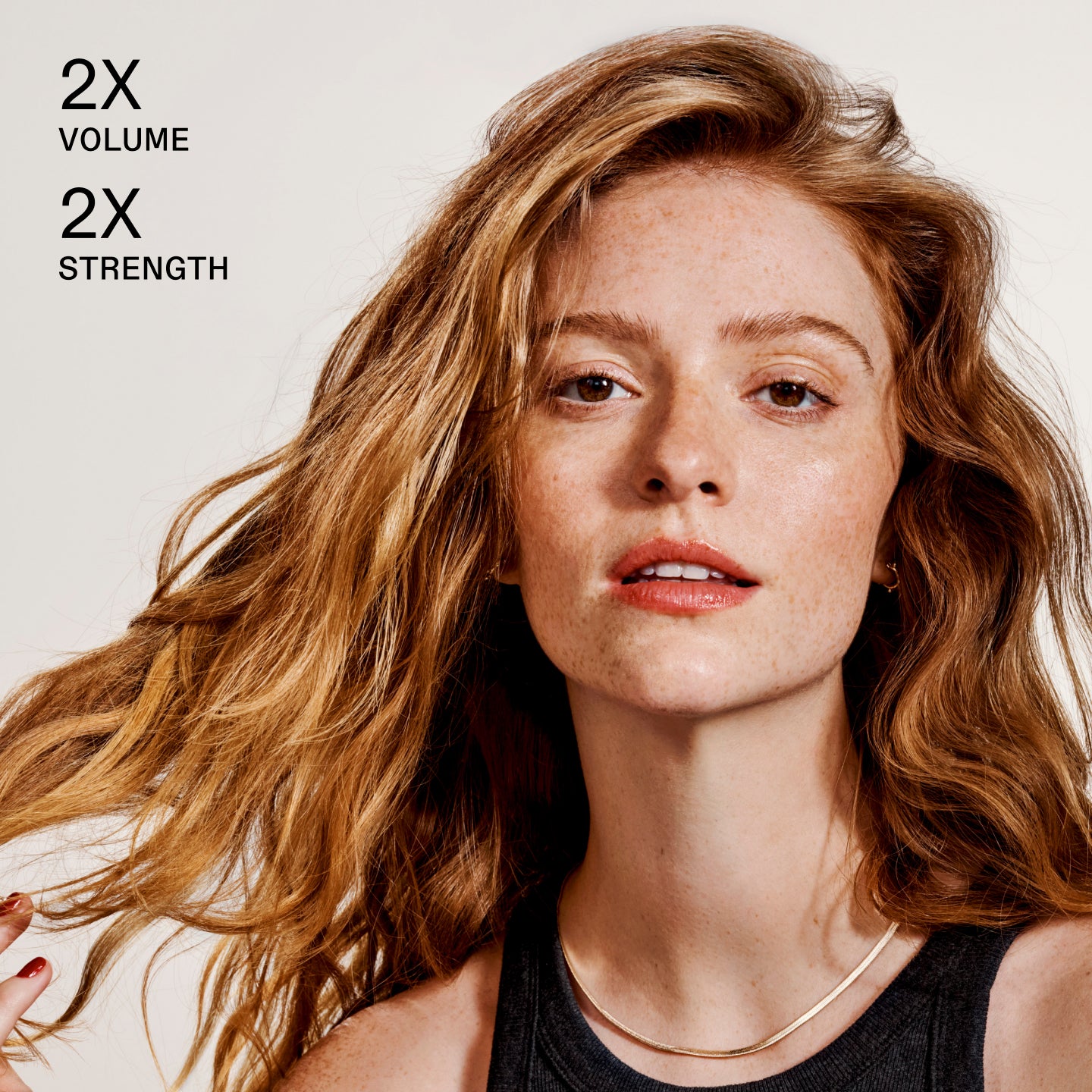 Large text overlay: "DOUBLES HAIR VOLUME INSTANTLY AND ALL DAY"

Suggestion/Metadata (on the right): "Woman with voluminous hair against a plain background"
