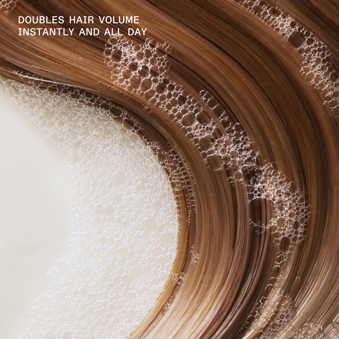 DOUBLES HAIR VOLUME INSTANTLY AND ALL DAY

Close-up of brown hair product with bubbles and text 'Doubles hair volume instantly and all day' on a white background.